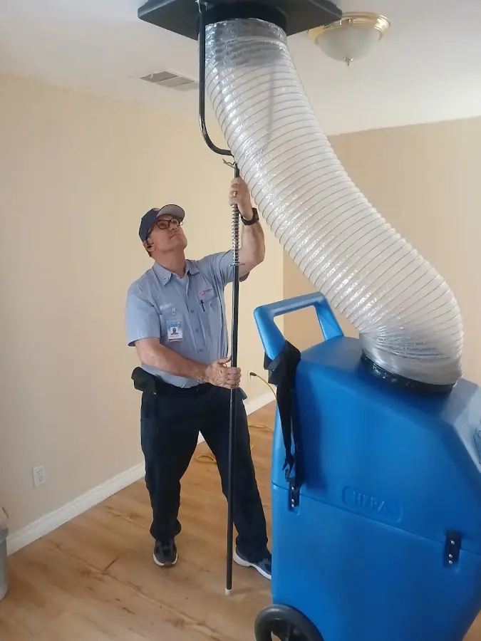 Furnace Tune-Up technician using HEPA equipment in Baltimore